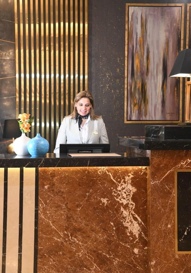 Tolip Gardens Hotel Каир Экстерьер фото A hotel receptionist at the front desk