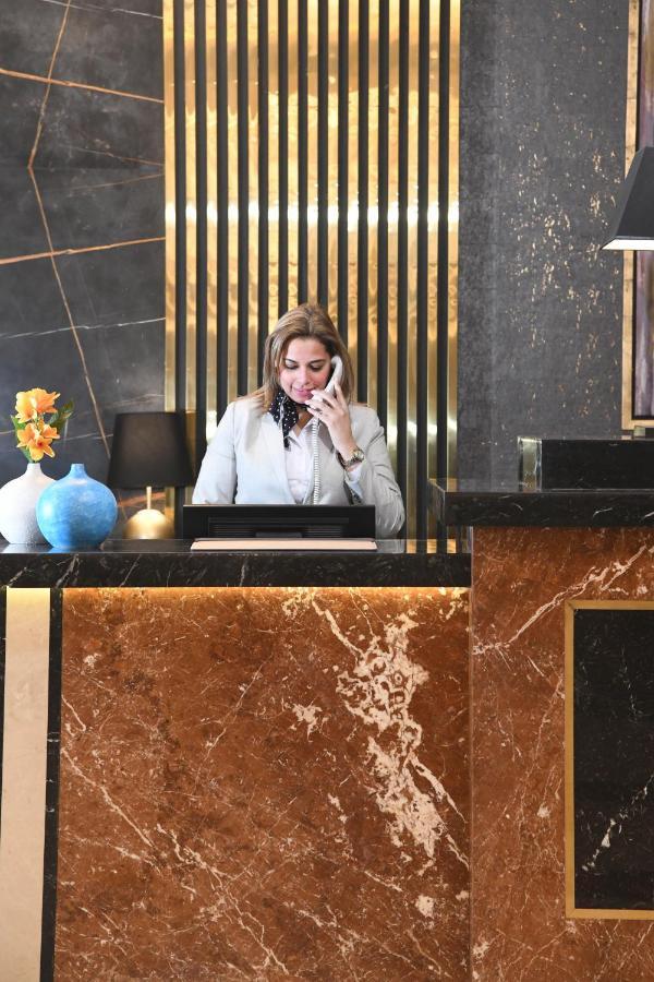 Tolip Gardens Hotel Каир Экстерьер фото A hotel receptionist
