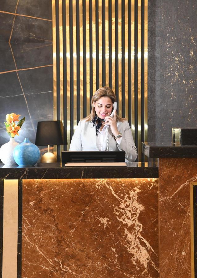 Tolip Gardens Hotel Каир Экстерьер фото A hotel receptionist